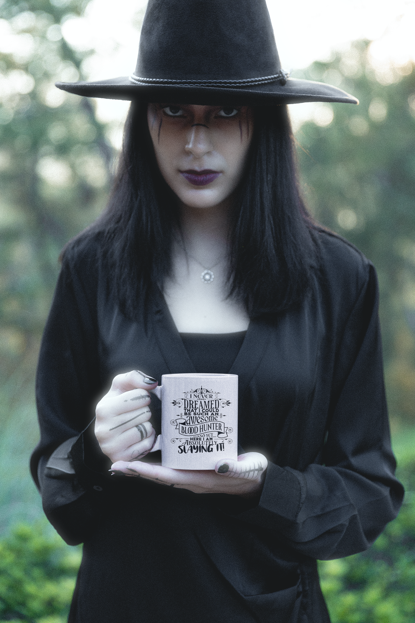 a woman wearing a black hat holding a book