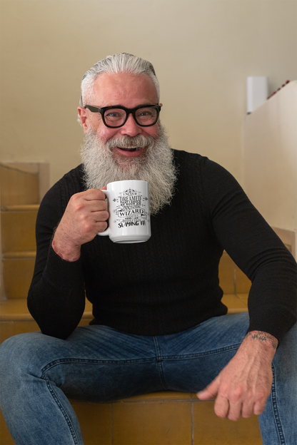 a man with a beard and glasses holding a coffee cup